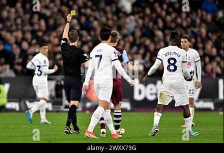 London, UK. 2nd Apr, 2024. John Brooks (Referee) shows the yellow card to Brennan Johnson (Spurs, 22) during the West Ham vs Tottenham Hotspur Premier League match at the London Stadium Stratford. This Image is for EDITORIAL USE ONLY. Licence required from the the Football DataCo for any other use. Credit: MARTIN DALTON/Alamy Live News Stock Photo