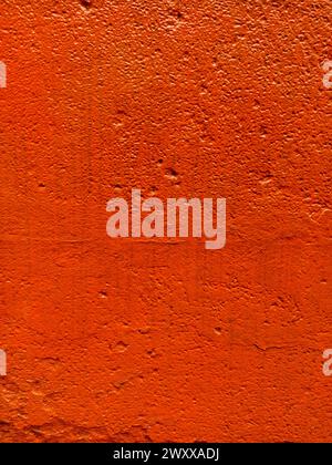 Blurred red stucco wall background  painted cement wall texture Stock Photo
