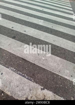 Crossing of road texture of pavement in perspective with white weathered paint Stock Photo
