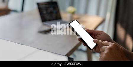 Top view Mockup image hand using a smartphone man Holding Cell Phone With Blank Screen Stock Photo