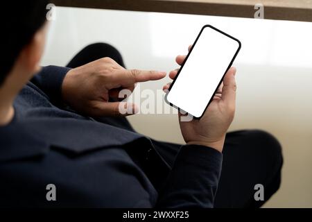 Top view Mockup image hand using a smartphone man Holding Cell Phone With Blank Screen Stock Photo