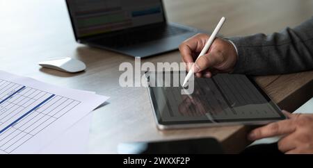 businessman uses a pen Signing The Digital Contract On Tablet Stock Photo