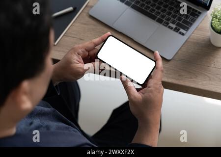Top view Mockup image hand using a smartphone man Holding Cell Phone With Blank Screen Stock Photo