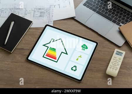 Energy Efficient House man use house icon with energy efficiency scale Invoice And Economy Stock Photo