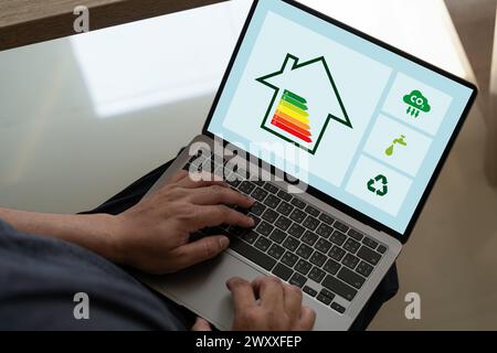 Energy Efficient House man use house icon with energy efficiency scale Invoice And Economy Stock Photo