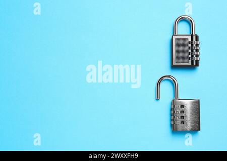Steel combination padlocks on light blue background, top view. Space for text Stock Photo