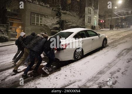 Pushing Cars In The Snow Stock Photo
