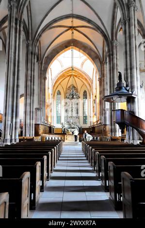 The Lutheran Church of St Thomas, Eglise Saint Thomas de Strasbourg, Alsace, view through the central aisle of a Gothic church with pews and stained Stock Photo
