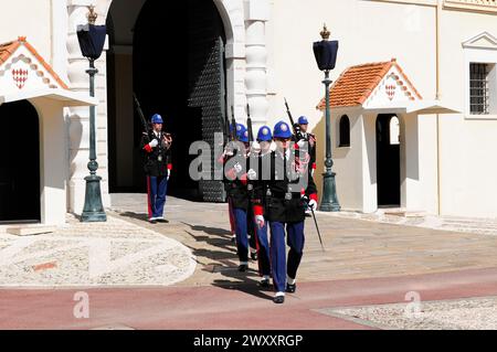 Changing of the Princely Guard at 12 o'clock in front of the Prince's Palace, Principality of Monaco, Uniformed guards march during a ceremony in Stock Photo