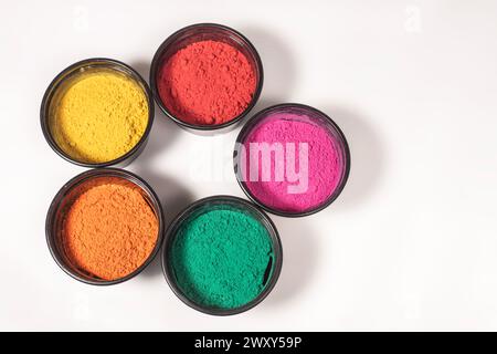 Top view of colorful traditional holi powder in bowl isolated on white background. Top view Stock Photo