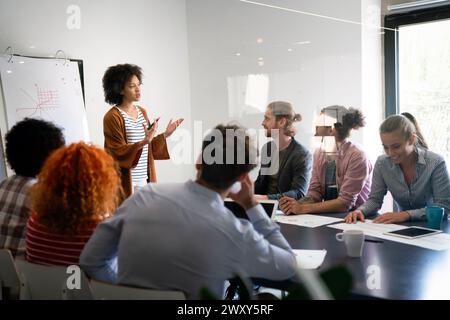 Young businesswoman leading a discussion during a meeting with her colleagues. Stock Photo