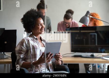 Diverse employees gathered in the office having fun during brainstorming while discussing new ideas Stock Photo
