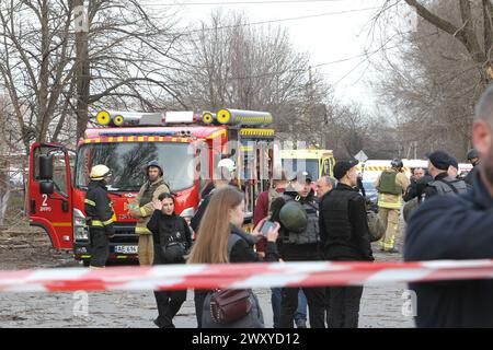 Non Exclusive: DNIPRO, UKRAINE - APRIL 02, 2024 - Police and rescuers are seen outside the building of an educational institution damaged by a Russian Stock Photo