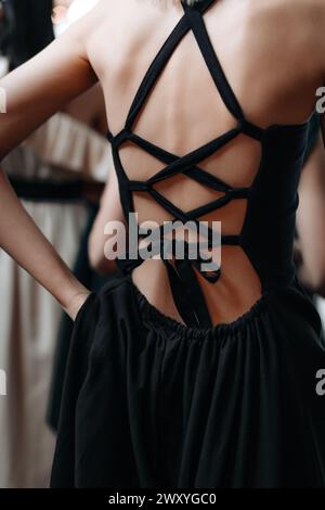 Elegant feminine fashion details of spring summer black dress with lace up  back. Back view Stock Photo - Alamy