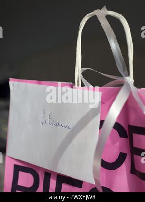 present in paper bag with name on greeting card envelope Stock Photo