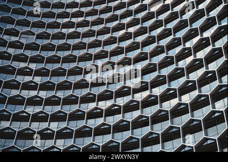 Close-up view of a contemporary building featuring a distinct geometric pattern made up of hexagonal structures Stock Photo
