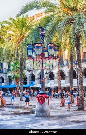 BARCELONA - AUGUST 8: Lantern designed by Antoni Gaudi in Placa Reial, scenic sightseeing and iconic square of the Gothic Quarter in Barcelona, Catalo Stock Photo