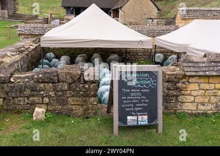 Pillars (pillars) of the hypocaust underfloor heating system are protected with winter socks - conservation in action. Chedworth Roman Villa, UK Stock Photo