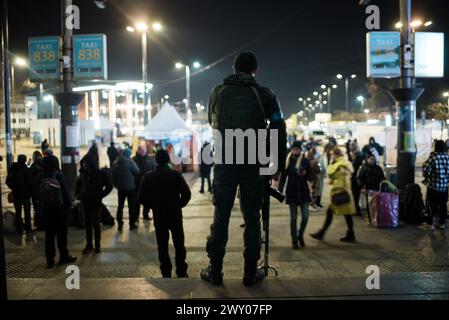 A Ukrainian soldier overlooks the entrance of the train station in Lviv. Lviv, Ukraine March 14, 2022. Stock Photo