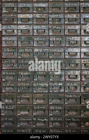 A cabinet with drawers for screws, nuts, bolts etc for sale at the final closing sale of an old agricultural engineering company in mid Wales, UK Stock Photo