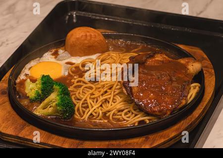sizzling grilled chicken chop with pasta Stock Photo