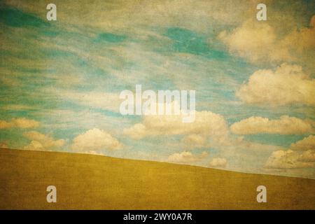 Vintage background of green field and blue cloudy sky Stock Photo