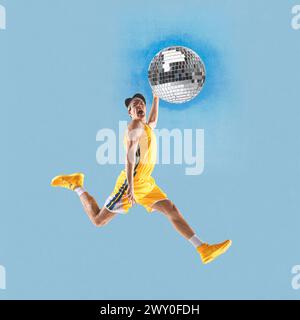 Poster. Contemporary art collage. Young athlete man, player playing disco ball as basketball ball against blue background. Stock Photo