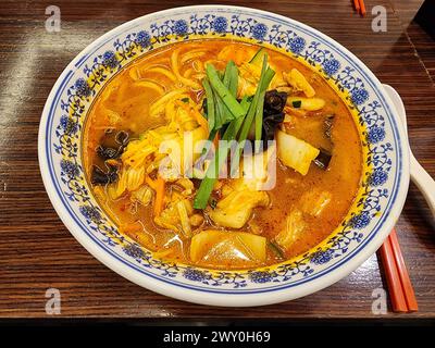 Jjamppong, a Chinese-style Korean noodle soup with red, spicy seafood- or pork-based broth flavored with chili powder. Stock Photo