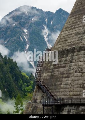 Metal steps leading vertically up the wall of a huge hydrolectric dam in Japan Stock Photo