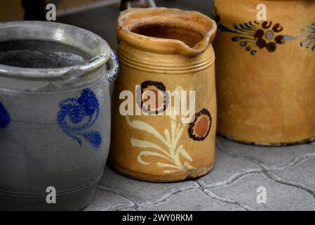 Antique Alsatian glazed pottery pitchers with old farmhouse motifs on display in Obernai, Alsace France. Stock Photo