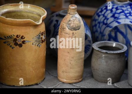 Antique Alsatian glazed pottery pitchers with old farmhouse motifs on display in Obernai, Alsace France. Stock Photo