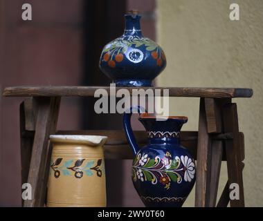 Antique Alsatian glazed pottery pitchers with old farmhouse motifs on display in Obernai, Alsace France. Stock Photo