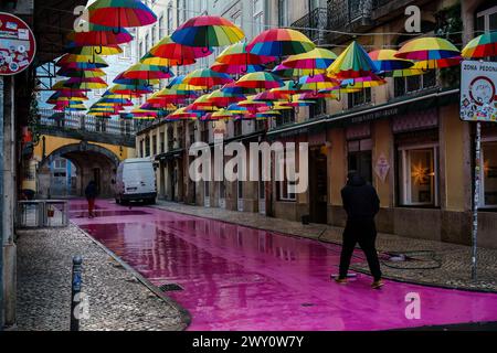 Street cleaners on Calle Rosa , the pink street in early morning. Lisbon, Portugal. February 2, 2024. Stock Photo