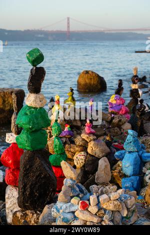 Art made from painted rocks on a Lisbon riverside, Lisbon, Portugal. February 1, 2024. Stock Photo