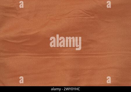 orange crumpled fabric texture background (fine mesh fabric with vignette, lines, checkered herringbone box pattern) cream Stock Photo