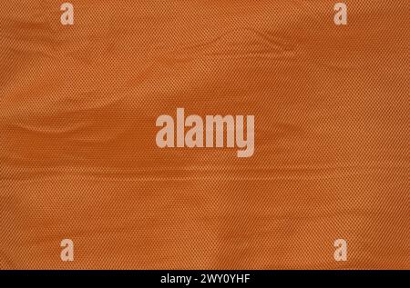 orange crumpled fabric texture background (fine mesh fabric with vignette, lines, checkered herringbone box pattern) cream Stock Photo