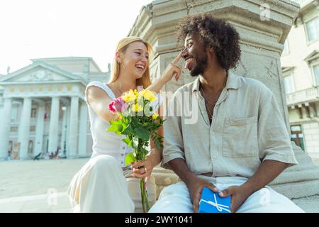 A loving couple spends a moment together, a man has a Valentine's gift for his partner. Stock Photo