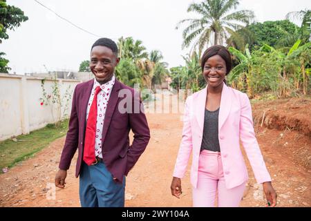 Two colleagues walking on their way to work, African business man and woman together smiling. Stock Photo