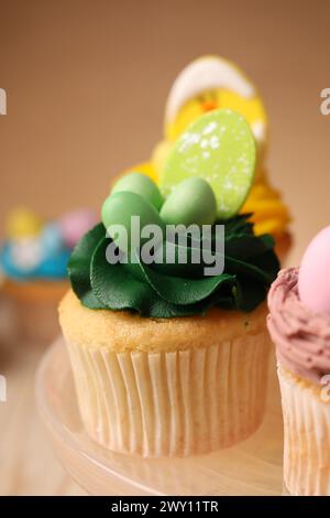 Tasty cupcake with Easter decor on stand, closeup Stock Photo