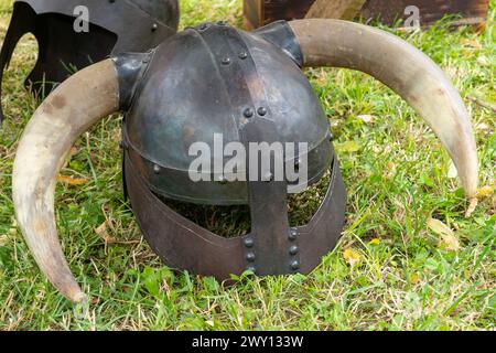 Medieval Viking wrought iron helmet with horns placed on the ground Stock Photo