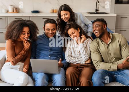 Group of friends using a laptop together Stock Photo