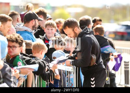 Coventry City's Liam Kelly signs autographs for fans ahead of the Sky Bet Championship match at the Coventry Building Society Arena, Coventry. Picture date: Monday April 1, 2024. Stock Photo