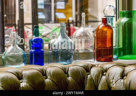 Multicolor vintage bottles on a windowsill Stock Photo