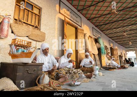 A man who manufactures traditional products from local raw materials, Darb Al Saai celebrations of Qatar National day. Stock Photo