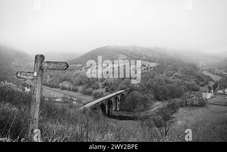 The mist and low cloud slowly lift from the Monsal Head Bridge pictured above the Monsal trail in March 2024. Stock Photo