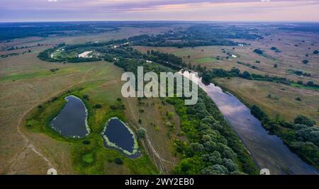 Beautiful Ukrainian nature background. Drone view on riverbank of the Seym river and amazing cloudscape over it. Summertime. Stock Photo