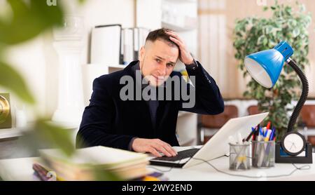 Angry male manager experiencing emotions in office Stock Photo