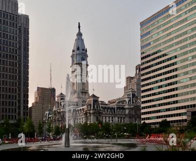 A fountain arcs over Love Park in front of Philadelphia City Hall. Stock Photo