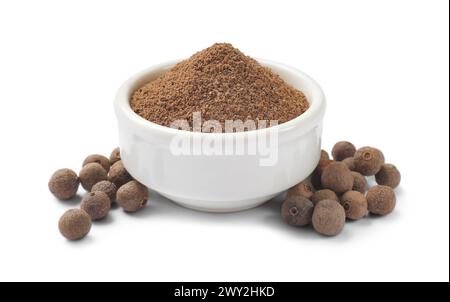 Ground and whole allspice berries (Jamaica pepper) isolated on white Stock Photo