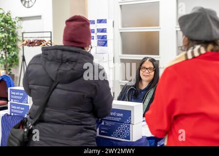 Detroit, Michigan - A representative for DTE Energy hands out energy-saving LED light bulbs at a community health fair. Stock Photo